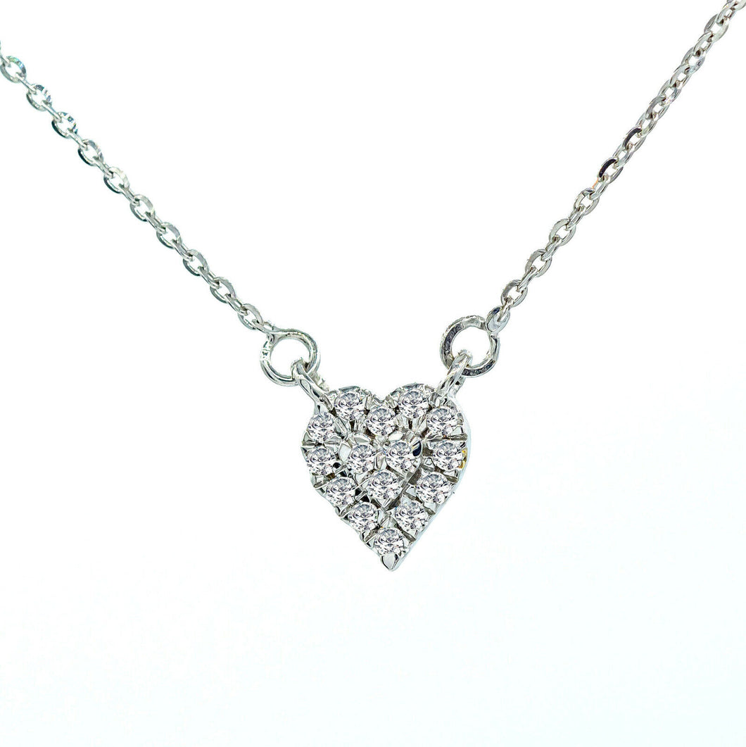 Minimalist diamond heart pendant 18k white gold and 18-inch adjustable chain.